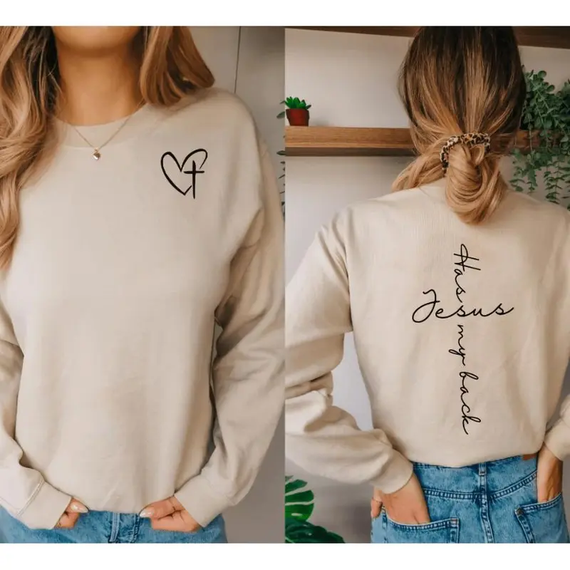 Jesus Has My Back crewneck sweatshirt, small heart cross on the chest and vertical script on the back