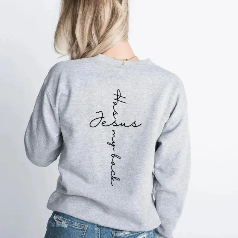 Jesus Has My Back crewneck sweatshirt, small heart cross on the chest and vertical script on the back