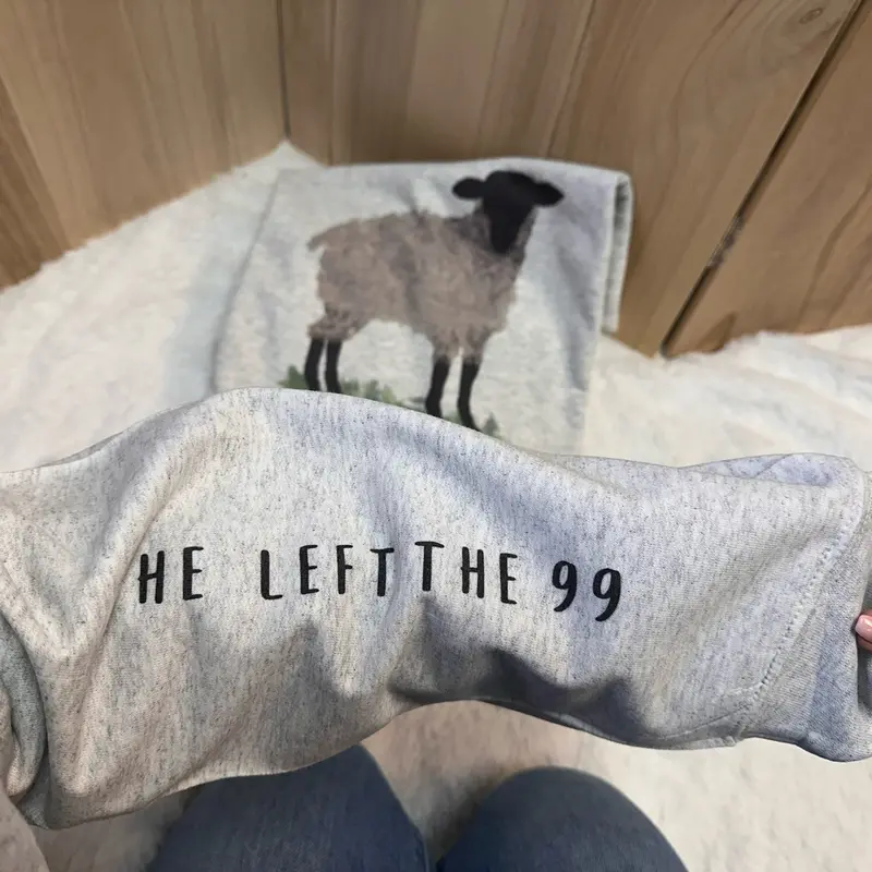 He Left The 99 sweatshirt with watercolor sheep on the chest and sleeve print on ash gray