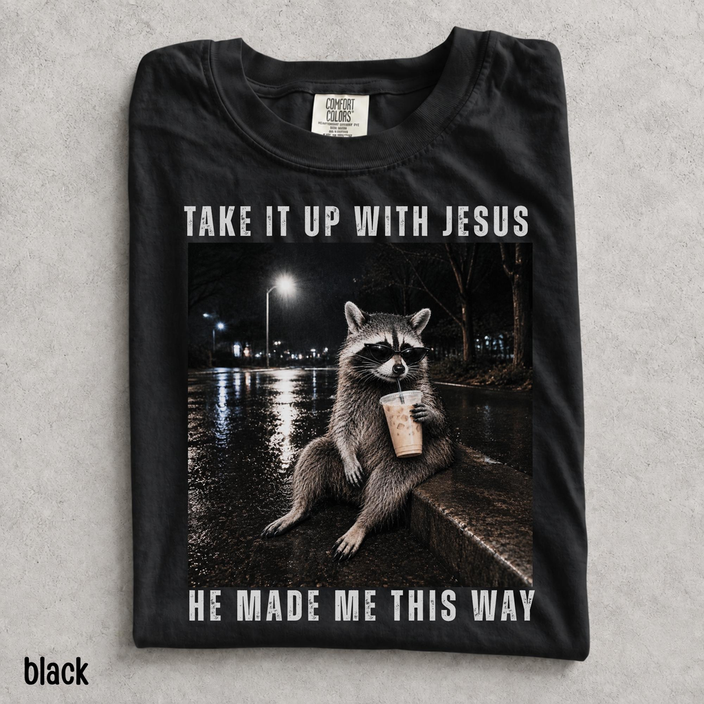 Take It Up With Jesus He Made Me This Way shirt, grunge raccoon in sunglasses sipping iced coffee on a rainy street