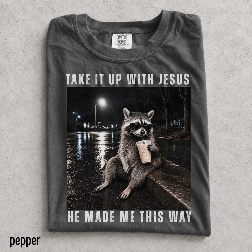 Take It Up With Jesus He Made Me This Way shirt, grunge raccoon in sunglasses sipping iced coffee on a rainy street
