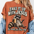 Take It Up With Jesus He Made Me This Way shirt, funny raccoon in sunglasses lounging with an iced coffee