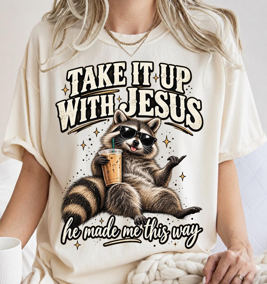 Take It Up With Jesus He Made Me This Way shirt, funny raccoon in sunglasses lounging with an iced coffee