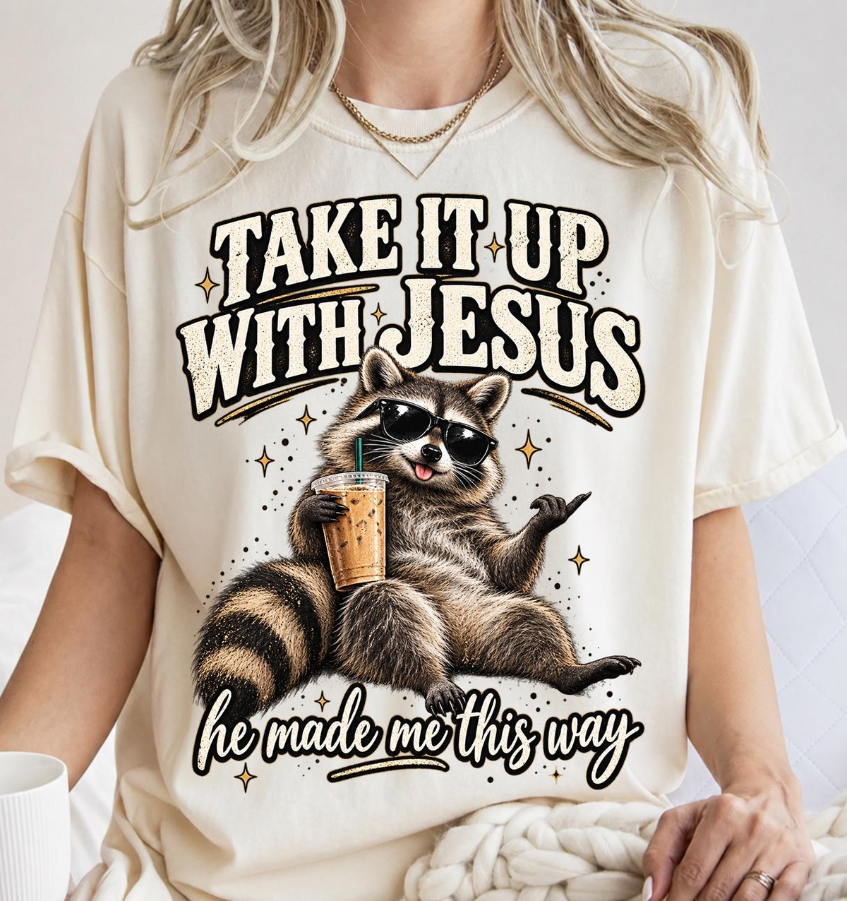 Take It Up With Jesus He Made Me This Way shirt, funny raccoon in sunglasses lounging with an iced coffee