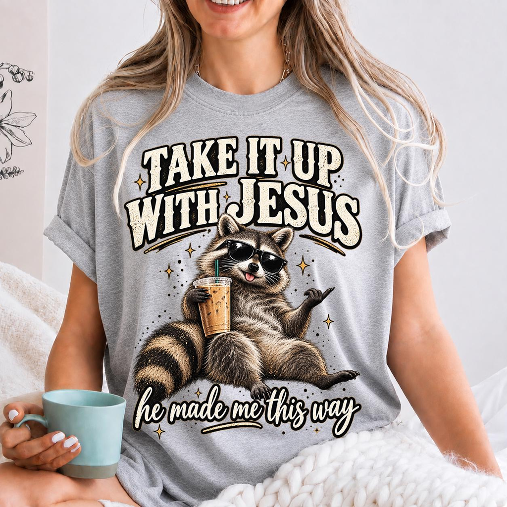 Take It Up With Jesus He Made Me This Way shirt, funny raccoon in sunglasses lounging with an iced coffee